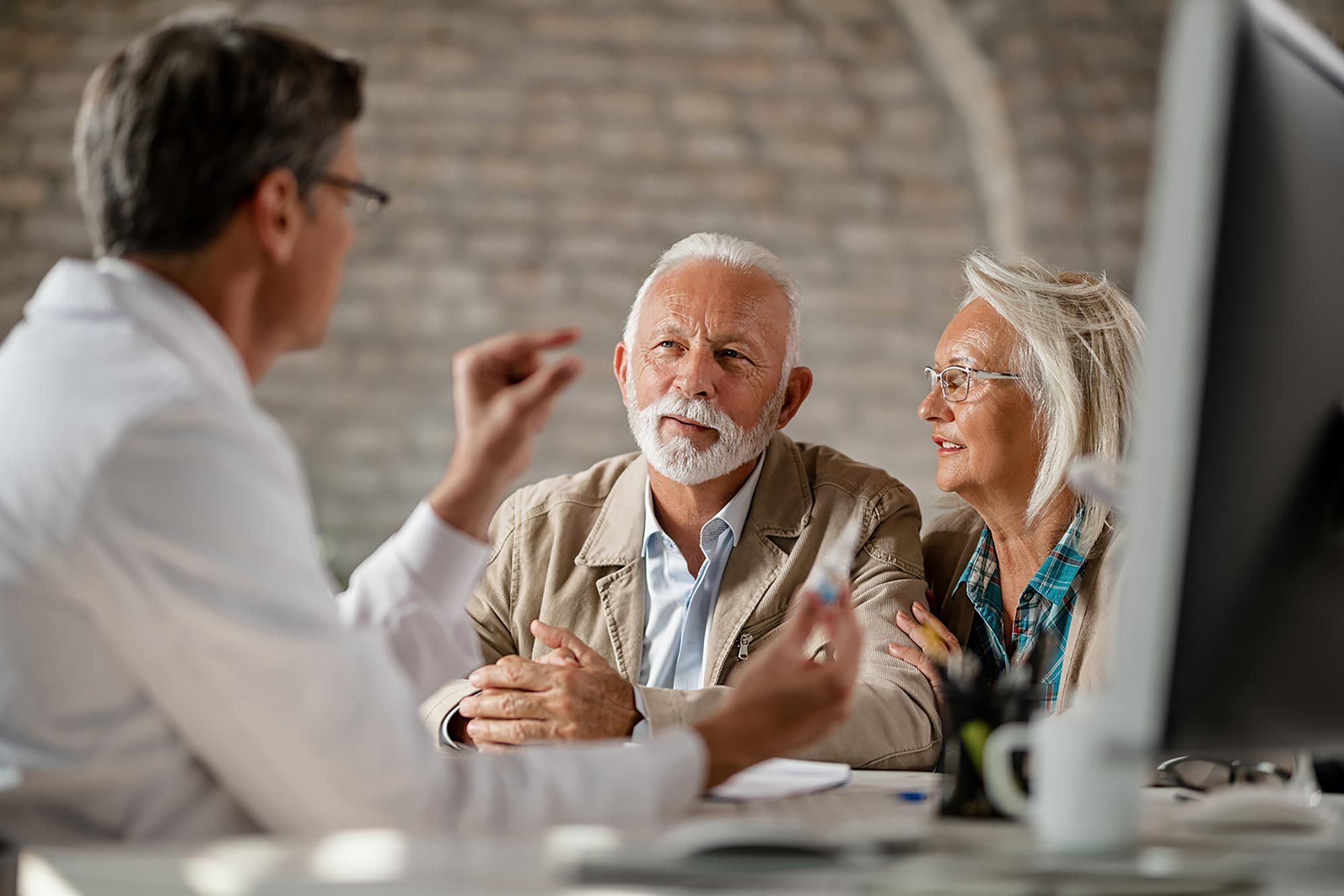 Senior travelers reviewing travel insurance options for pre-existing medical conditions
