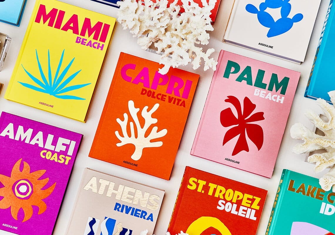 Collection of Assouline Travel Series luxury coffee table books displayed in a curated arrangement