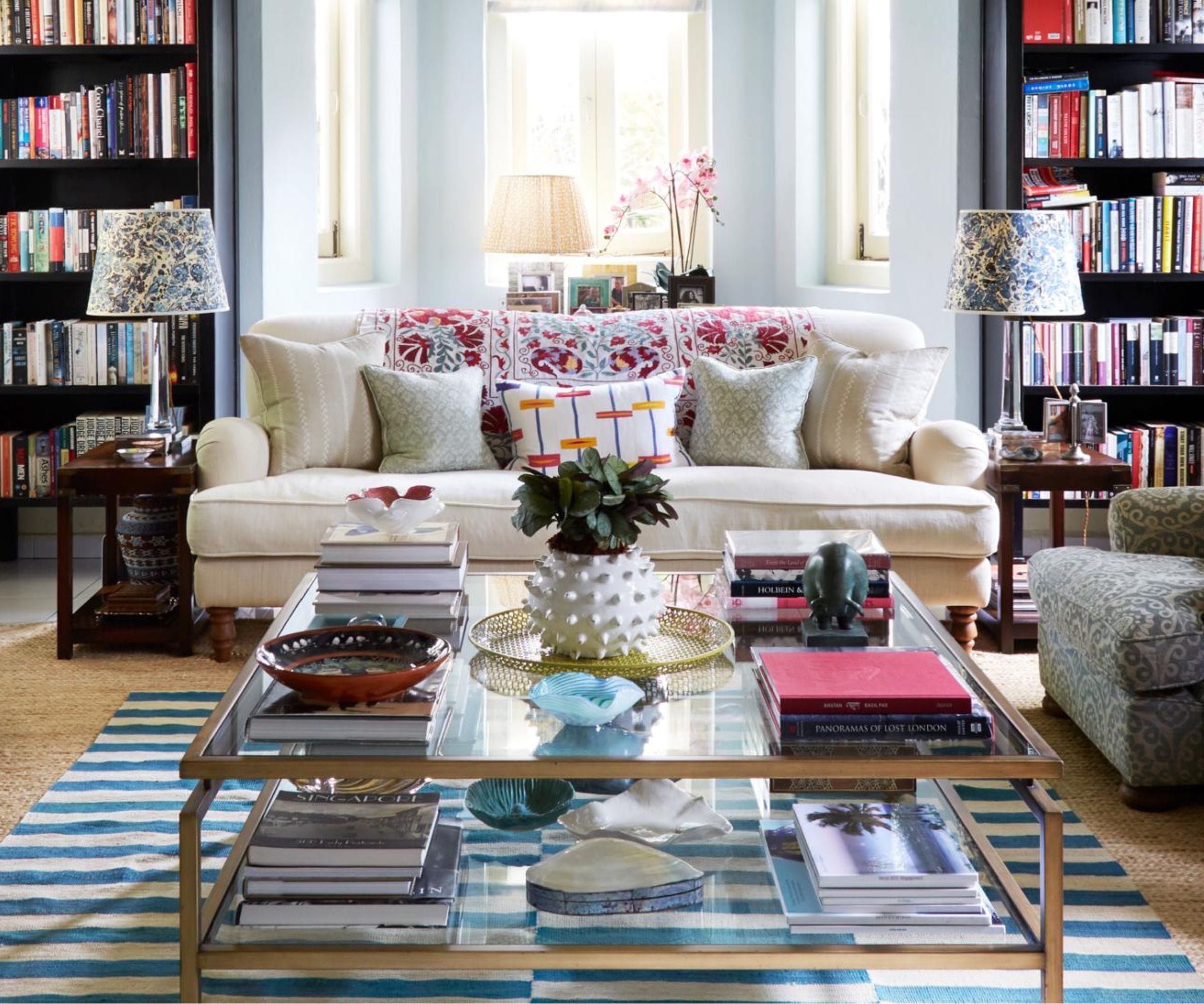 Coffee table books styled in a beautiful interior design setting showing the stacking trend