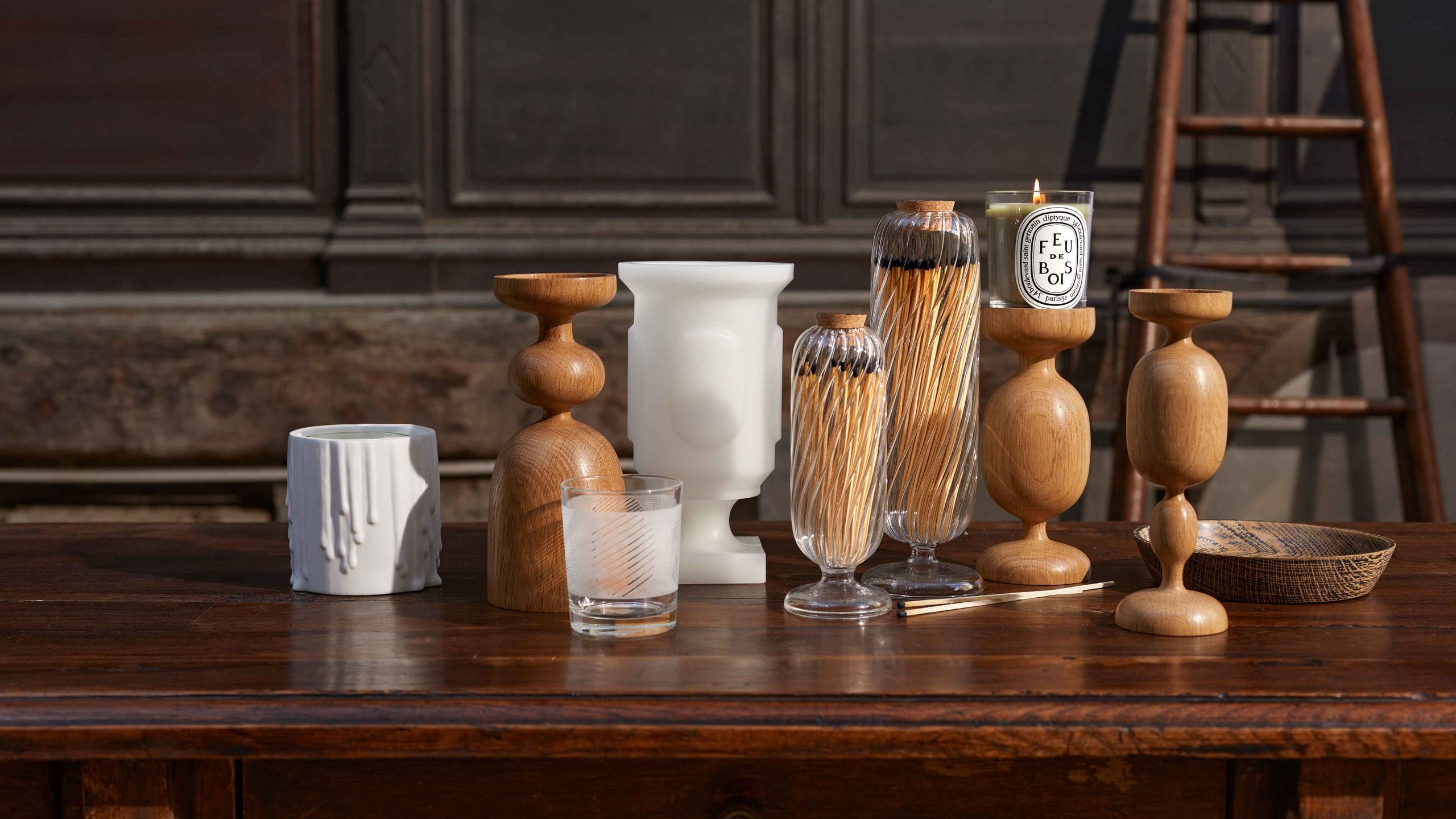 Diptyque luxury candle collection and home decor objects displayed elegantly