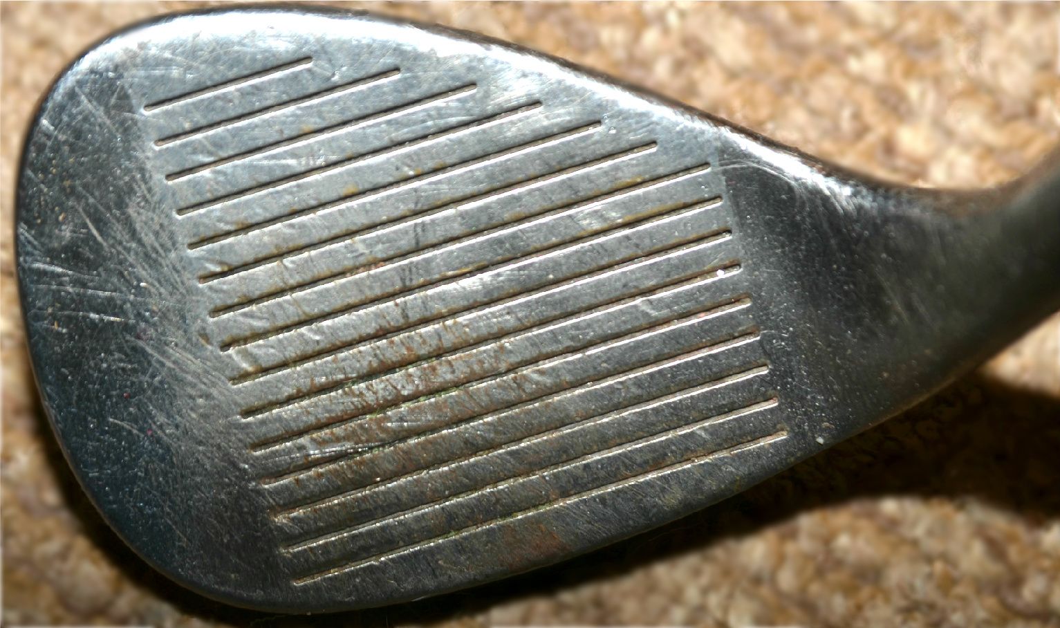 Close-up of golf club groove wear indicators showing when grooves are worn out