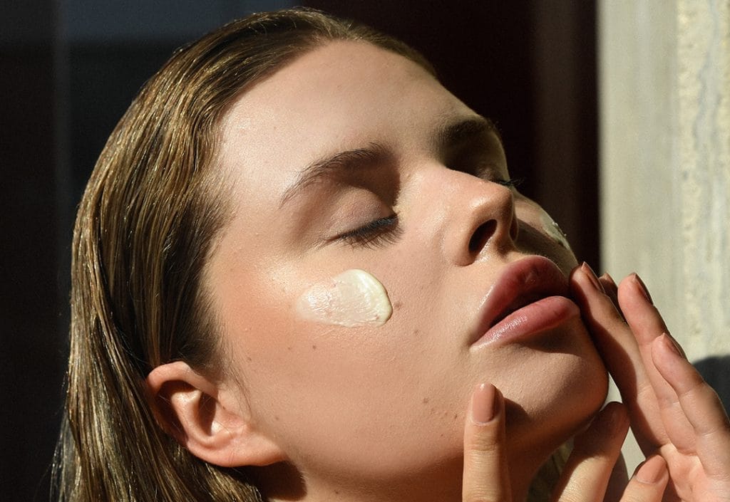 Luxury skincare routine with anti-aging cream application-couponsscout.com