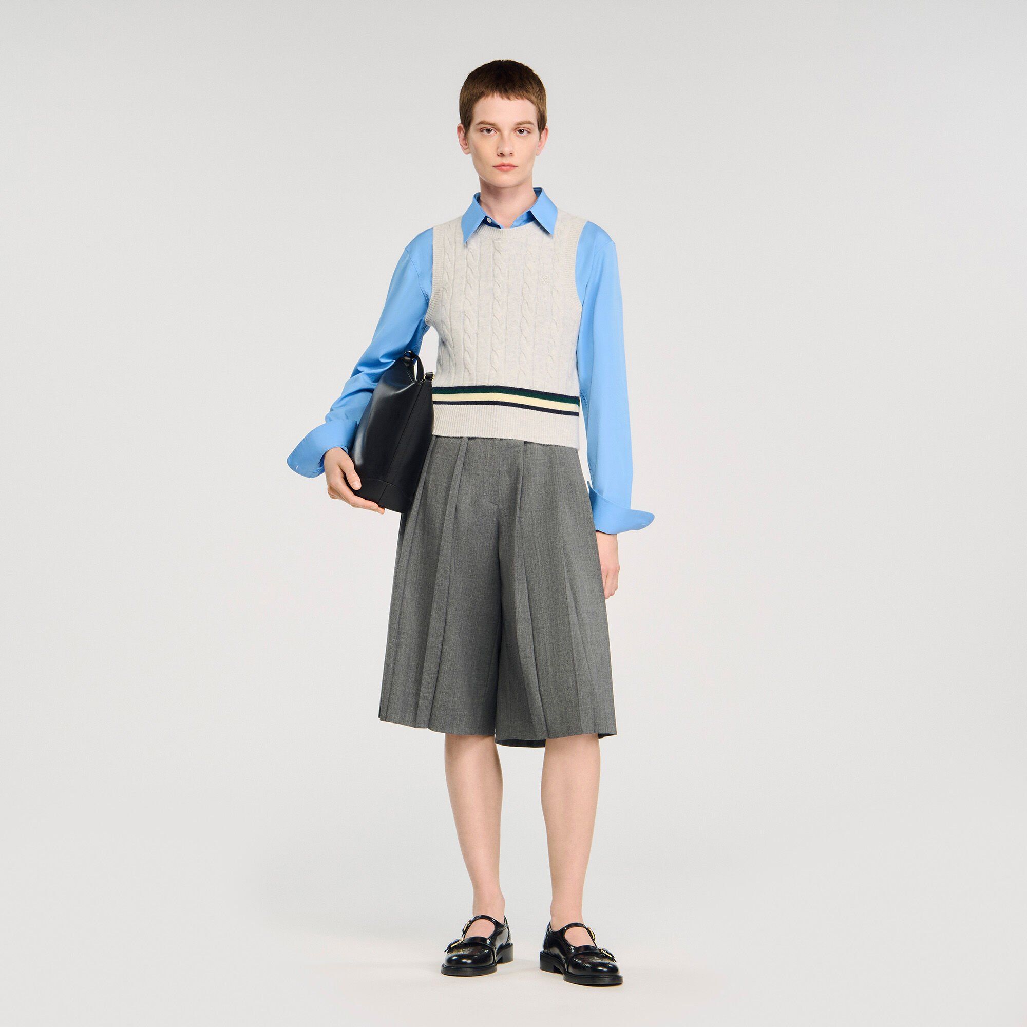 Sandro Paris sleeveless cropped cable knit sweater in grey showcasing their knitwear collection