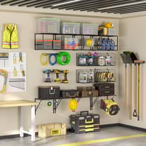 Wall-mounted garage shelving system with wire shelves for organizing tools and storage bins