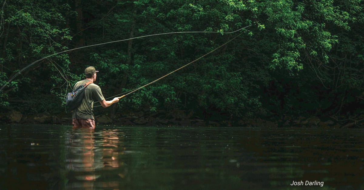Fly fishing rod casting technique demonstration on a river