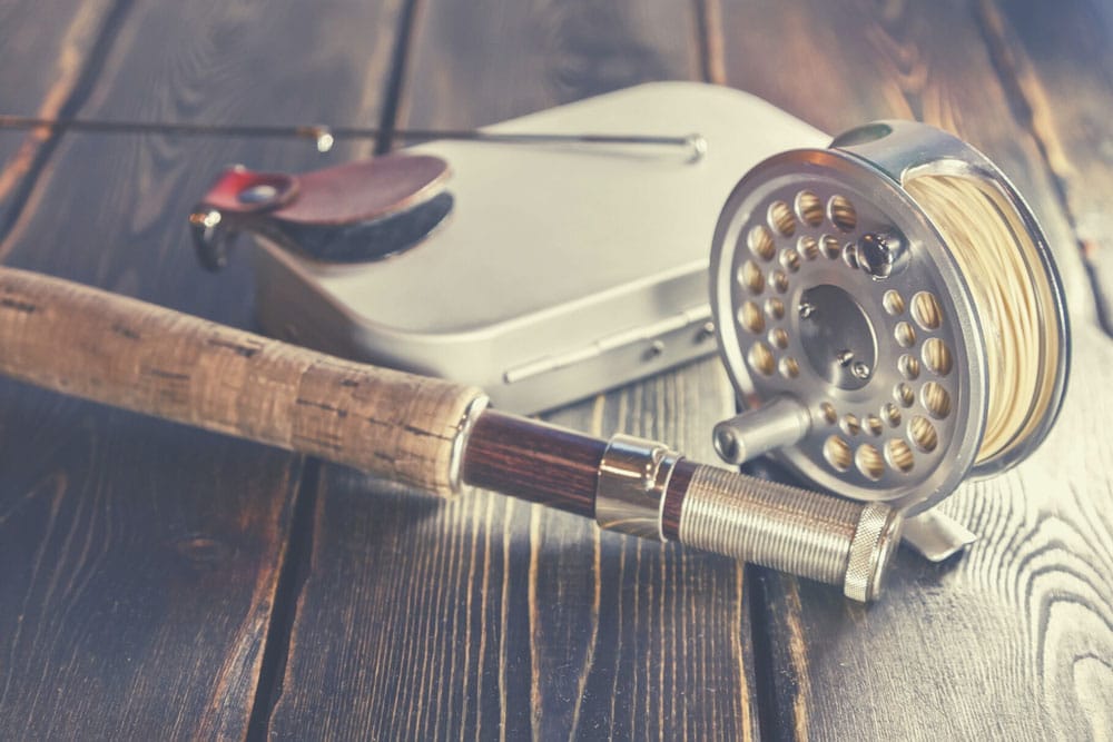 Essential fly fishing gear including rods, reels, flies, and accessories for beginners