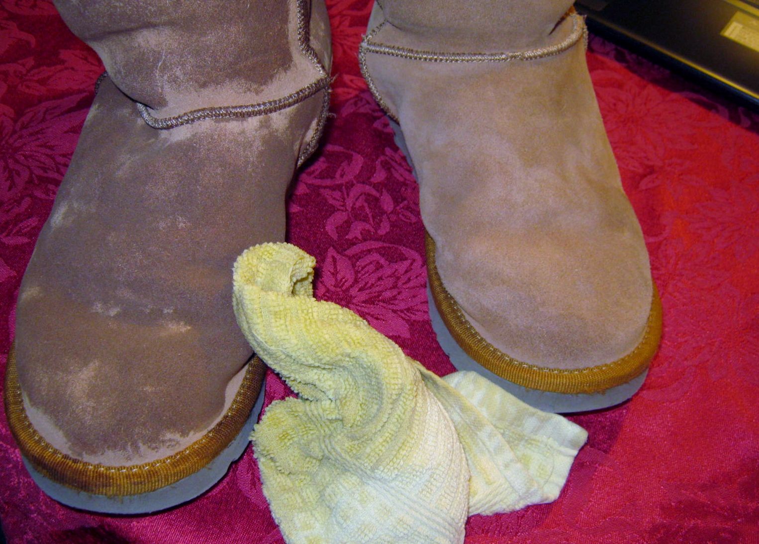 UGG boots with water stains and damage on suede surface
