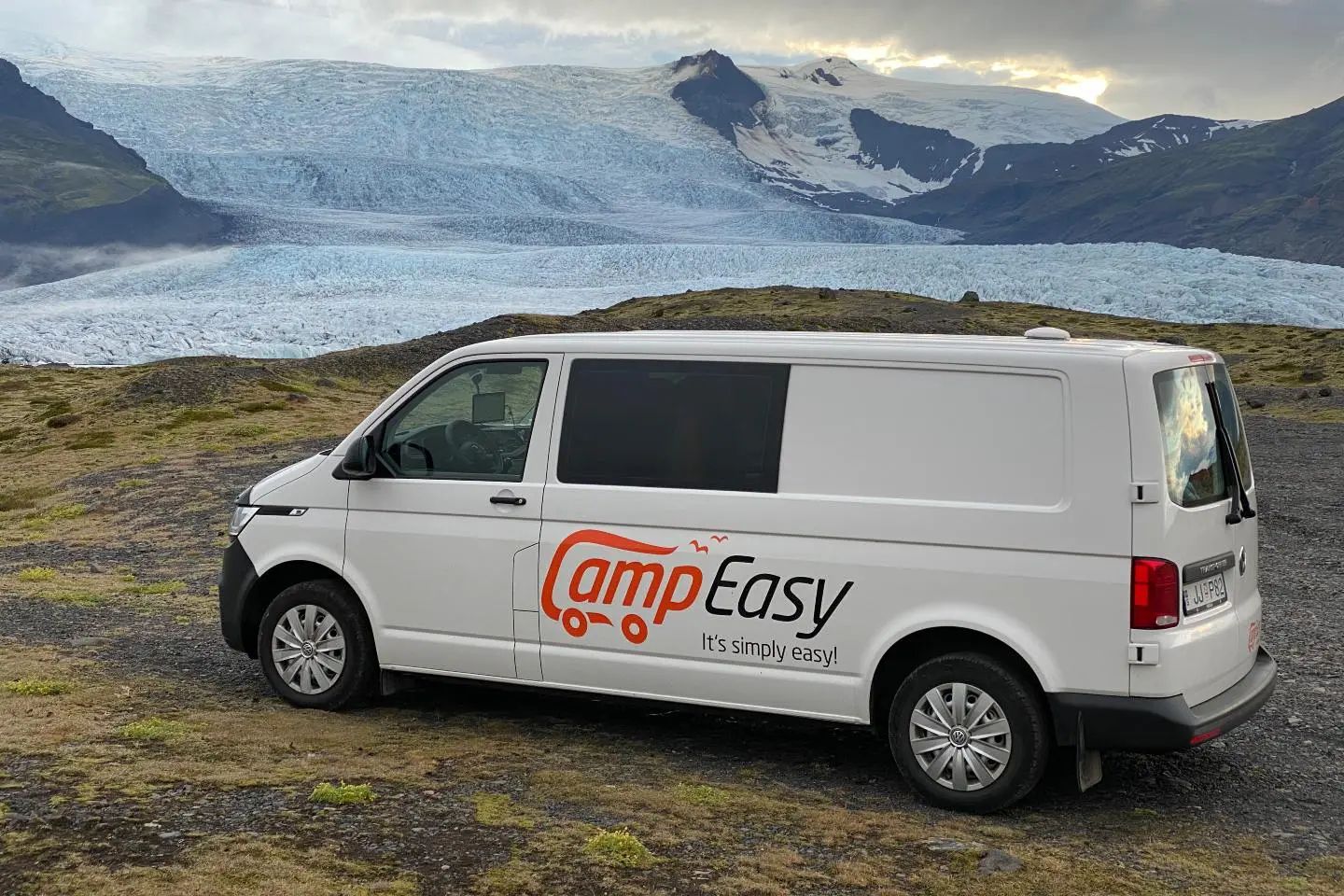 CampEasy Iceland campervan parked beside scenic coastal landscape during road trip