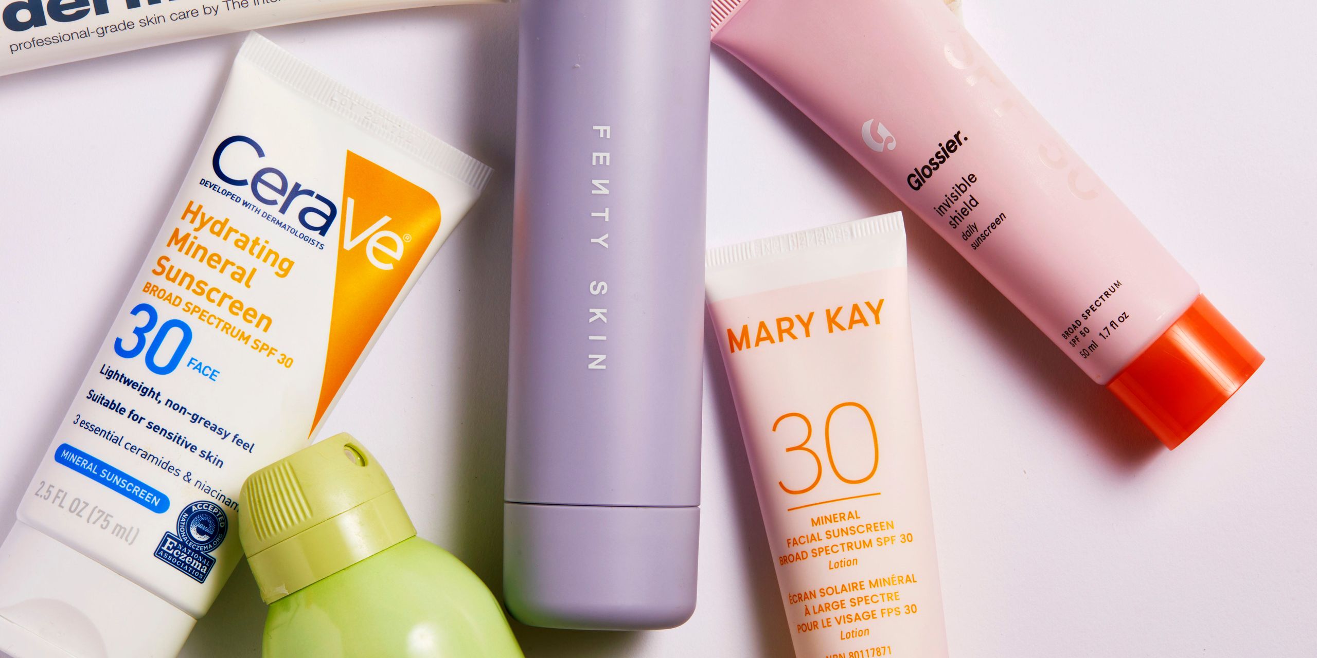 Selection of facial sunscreen and SPF moisturizer bottles arranged for editorial comparison