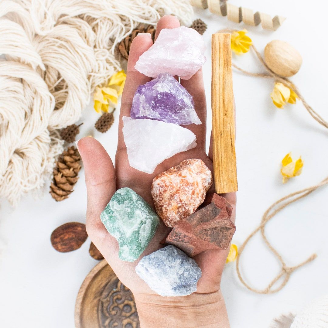 Natural raw healing crystals with palo santo sticks for ethical cleansing and smudging