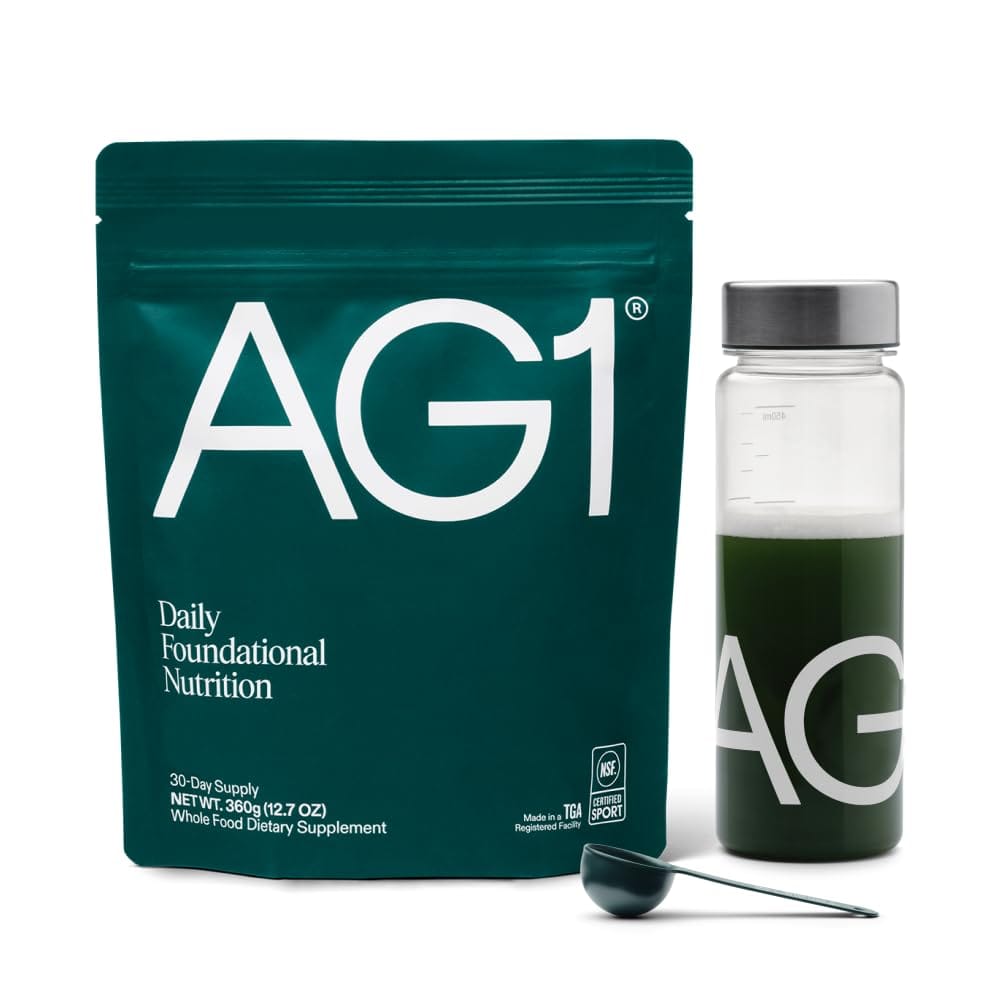 AG1 Athletic Greens powder canister with shaker and scoop showing 75 vitamins multivitamin probiotic blend