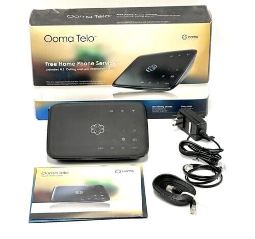 Voiply Review 2026: Is the Sub-$10 Price Worth the Widely-Reported Risks? -Ooma Telo Air wireless VoIP home phone adapter device shown with power cord accessory-couponsscout.com