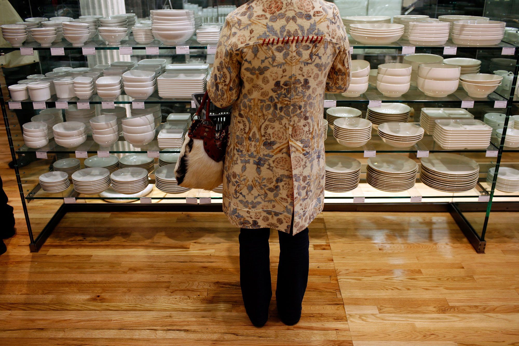 Muji store interior showing minimalist Japanese home goods on clean wooden shelves