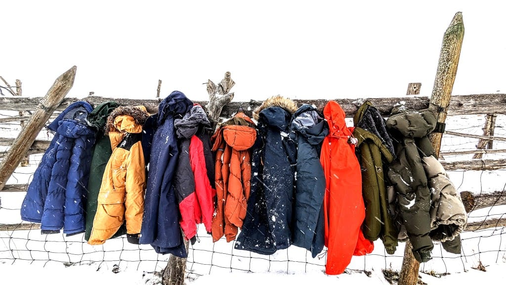 Premium winter jackets comparison testing in extreme cold weather conditions outdoor field setting