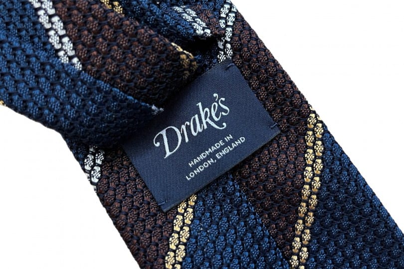 Drake's silk multistripe grenadine tie showing open-weave texture and rich knot dimple