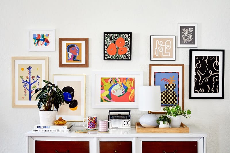 Society6 curated bedroom wall decor showcasing gallery-quality art prints in a styled boutique interior