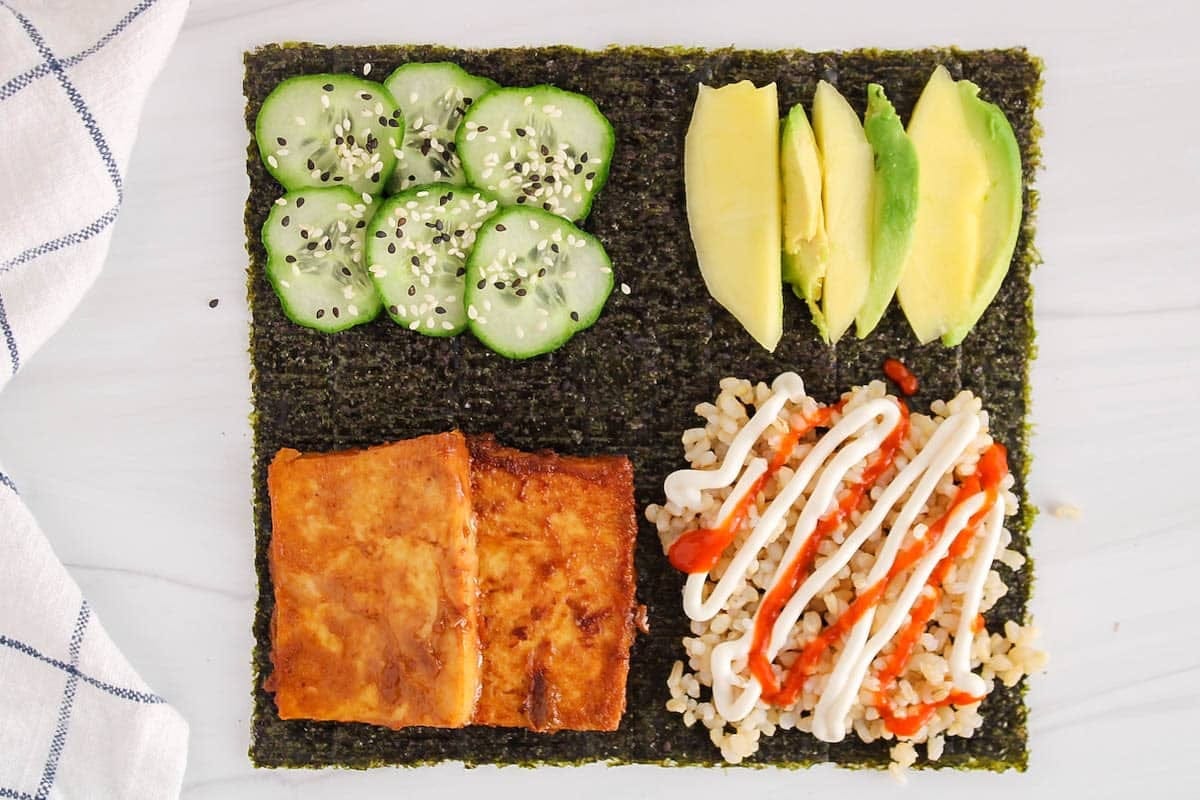 Nori seaweed sushi wrap rolled with fresh vegetables and protein as low-carb sandwich alternative