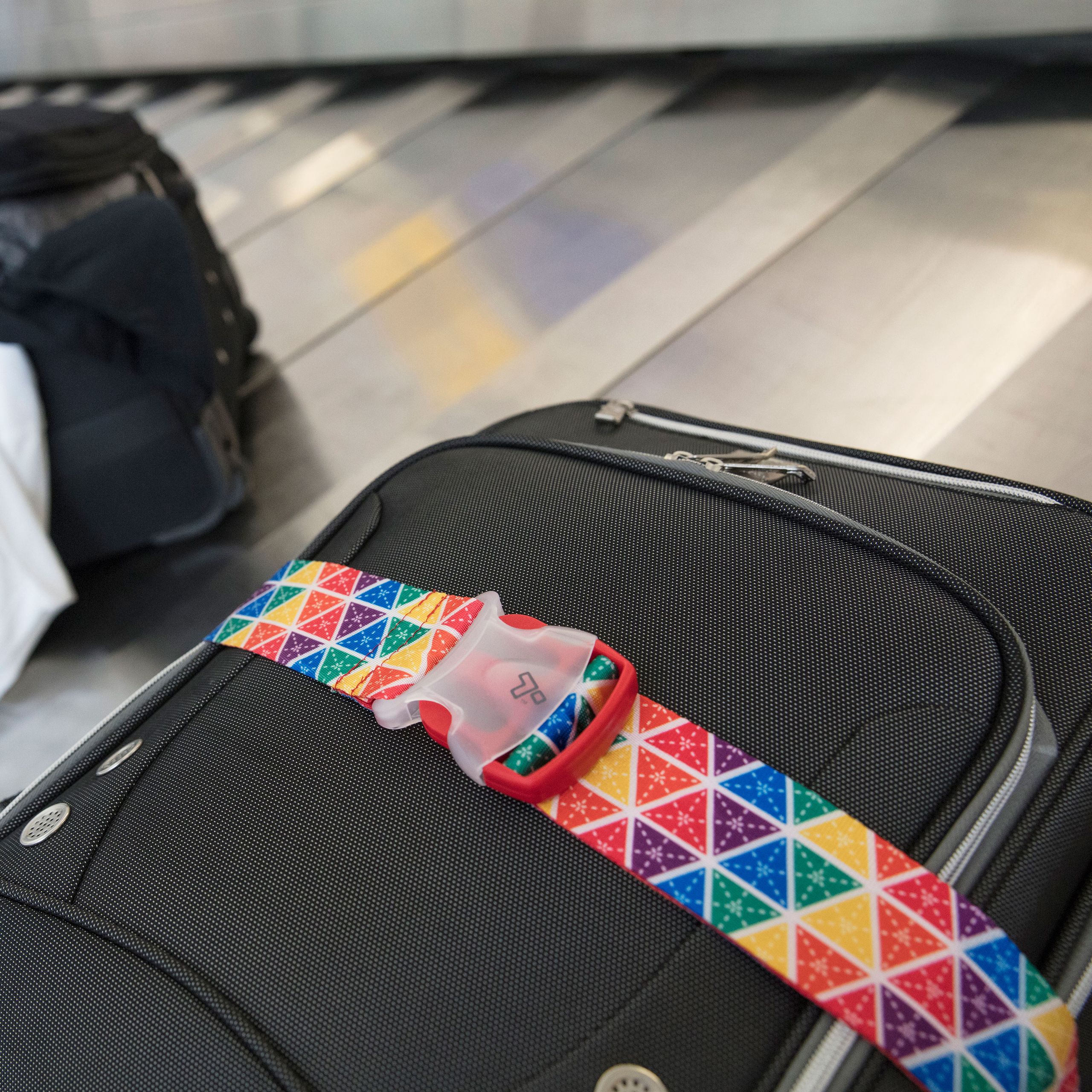 Travelon rainbow multi-colored locking luggage strap with 3-dial TSA combination lock for easy identification