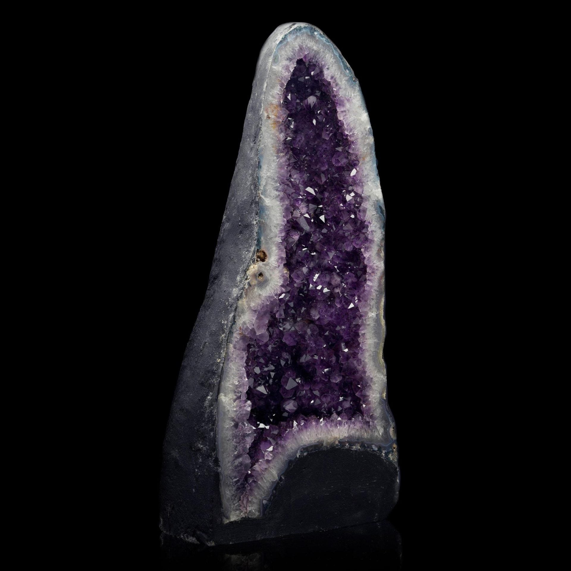 Large amethyst cathedral geode from Brazil showing deep purple crystals and natural home decor display