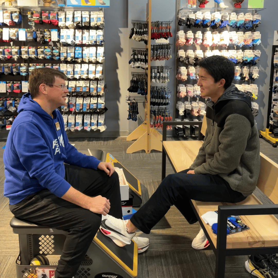 Fleet Feet in-store shoe fitting process with professional gait analysis specialist