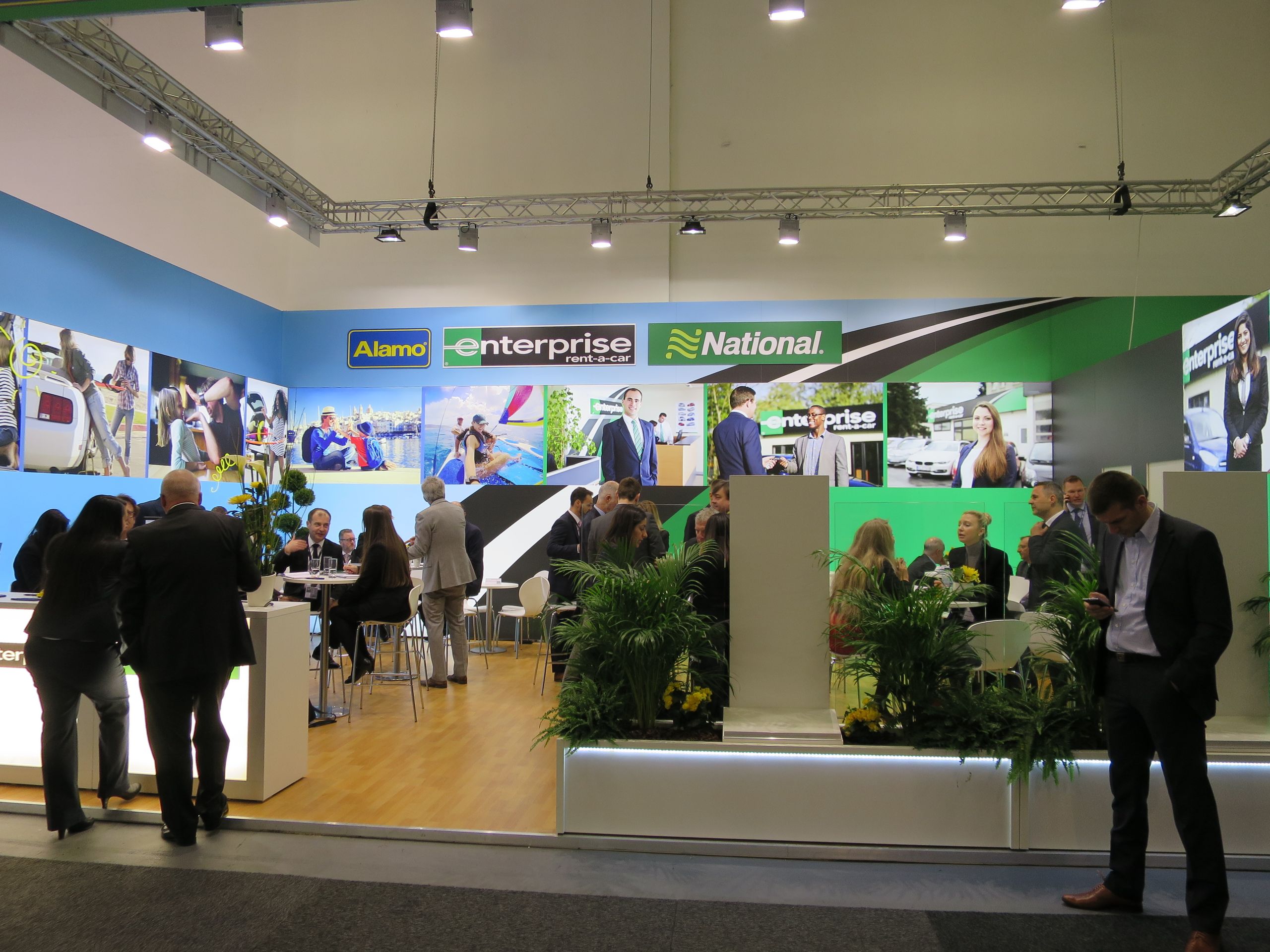 Alamo Review [2026]: Is the Value Worth the Risk? -Alamo Rent a Car and Enterprise Rent-A-Car brands displayed together at travel exhibition-couponsscout.com