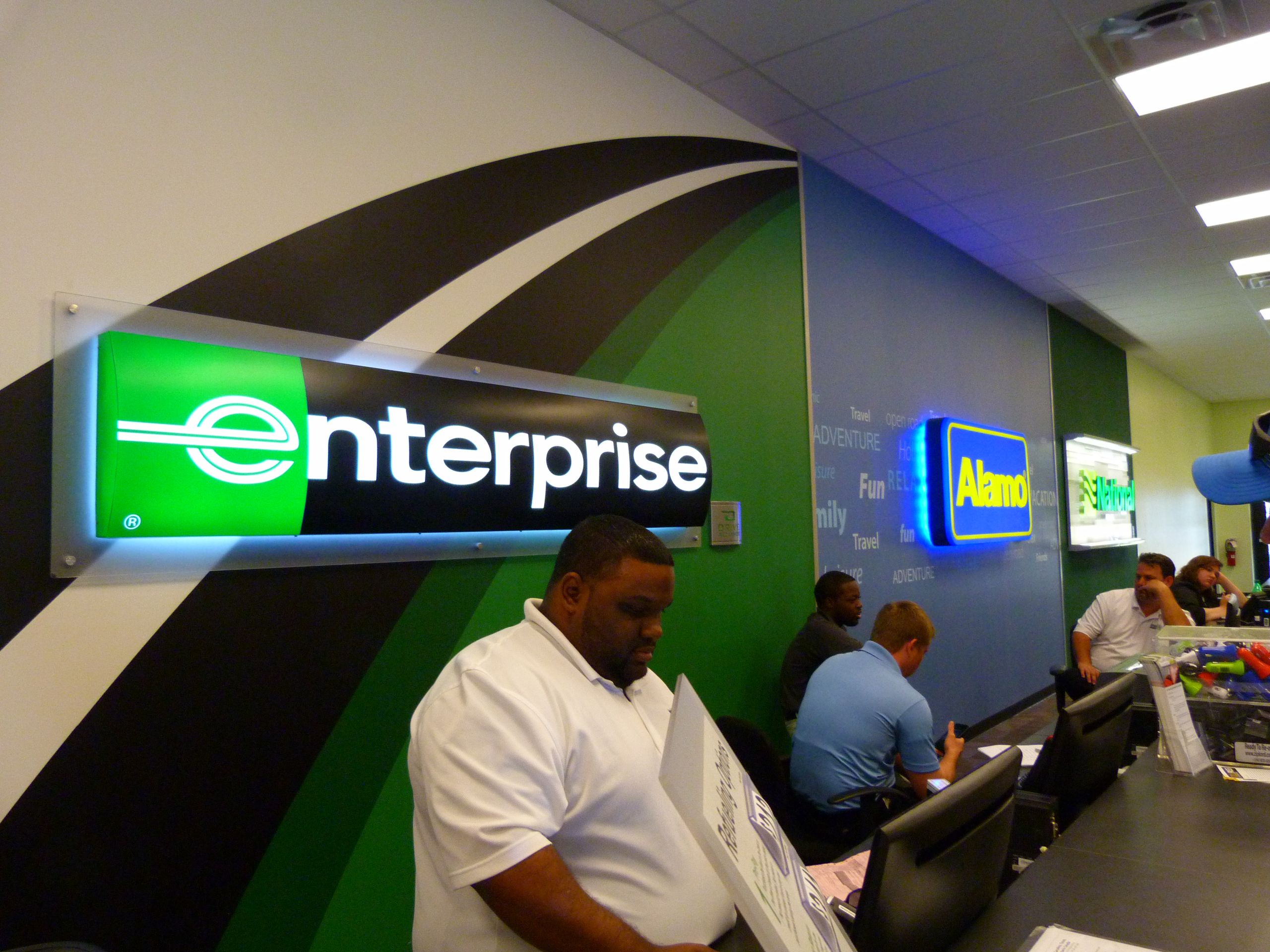 Enterprise Alamo and National car rental counter at major airport terminal