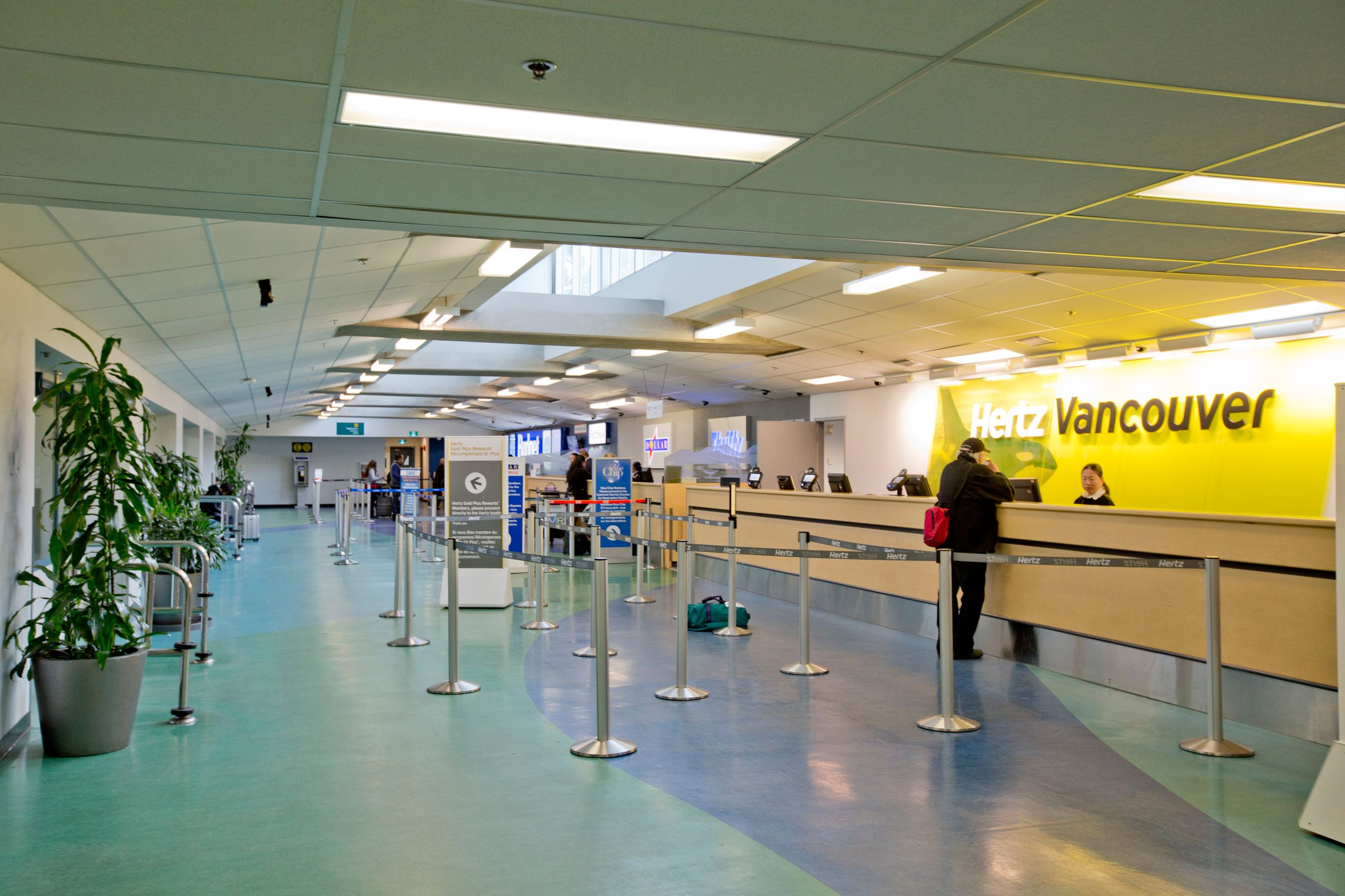 Hertz car rental counter at Vancouver International Airport showing brand signage