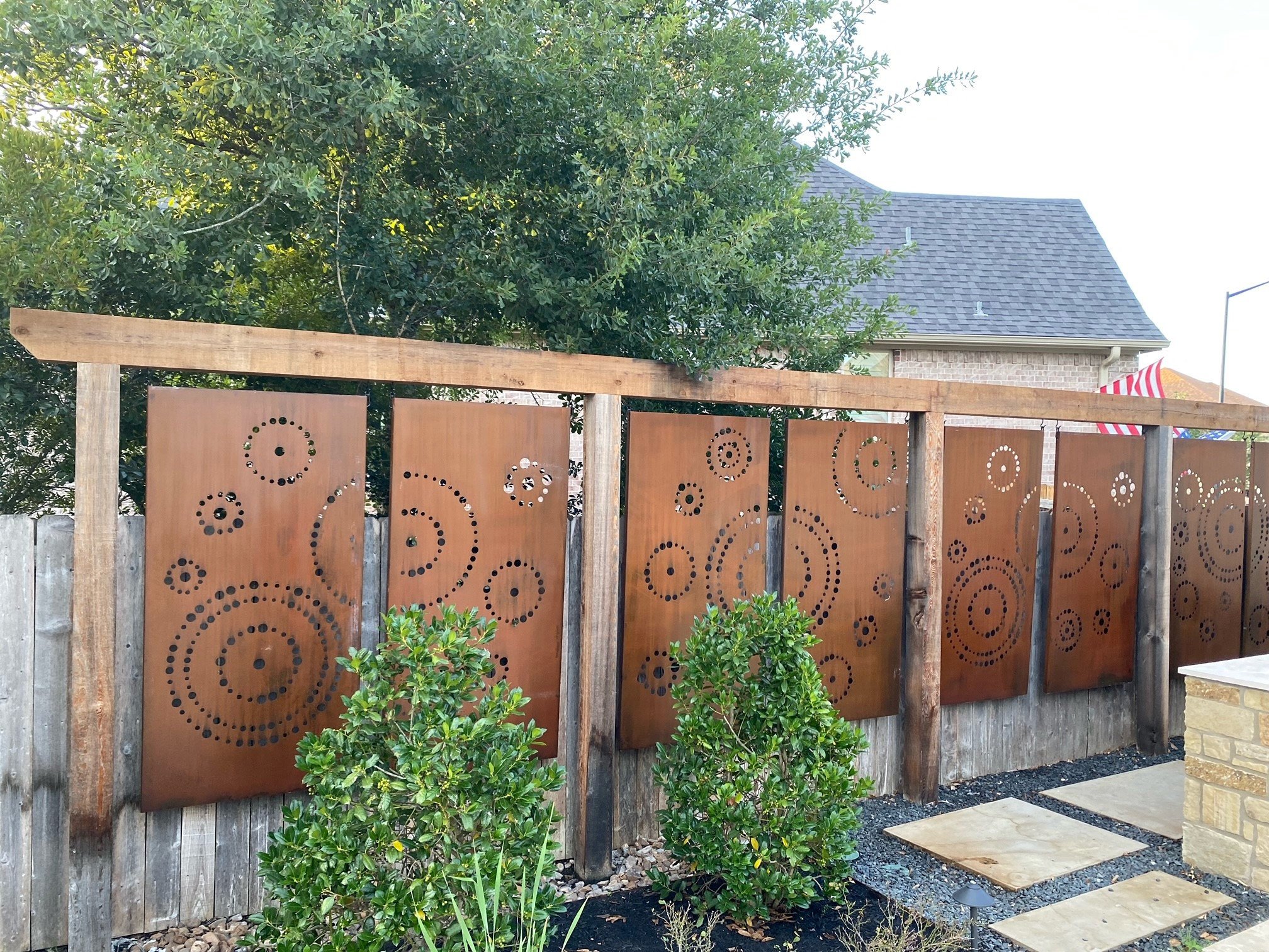 Custom made Corten steel privacy panels weathered rust patina finish garden installation