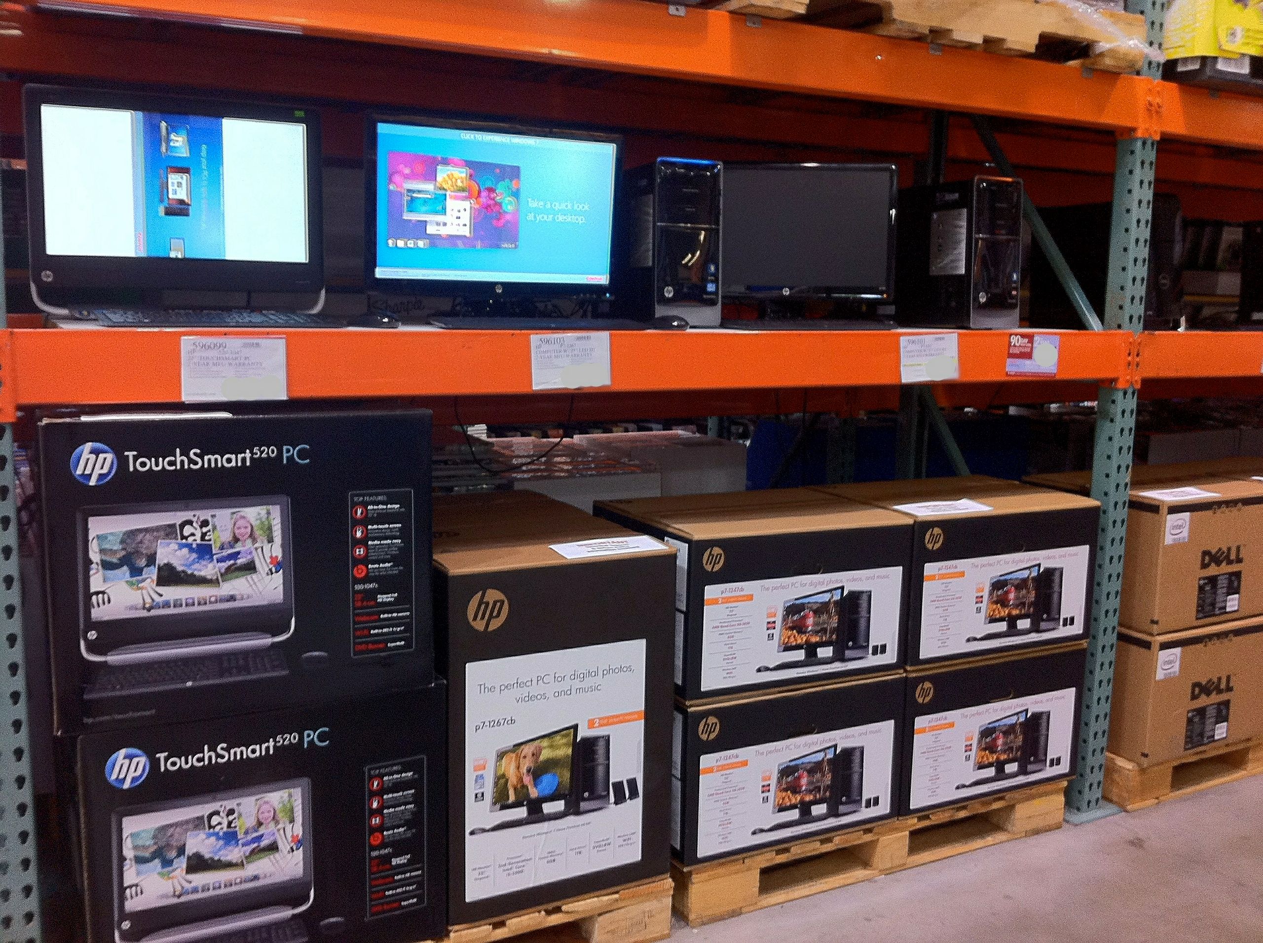 Costco warehouse electronics shelves showcasing bulk value pricing for mainstream TVs and PCs