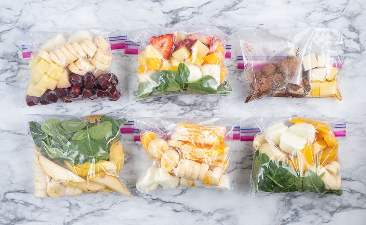 Homemade DIY frozen smoothie packs with fresh fruit and greens compared to subscription service