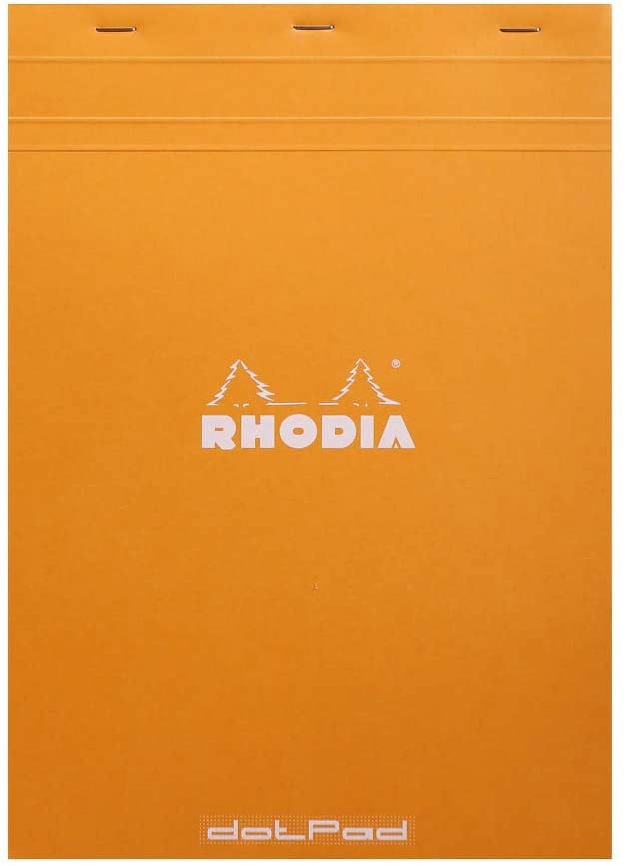 Rhodia dot grid notepad open on a desk showing 80 GSM vellum paper with violet 5mm dot pattern