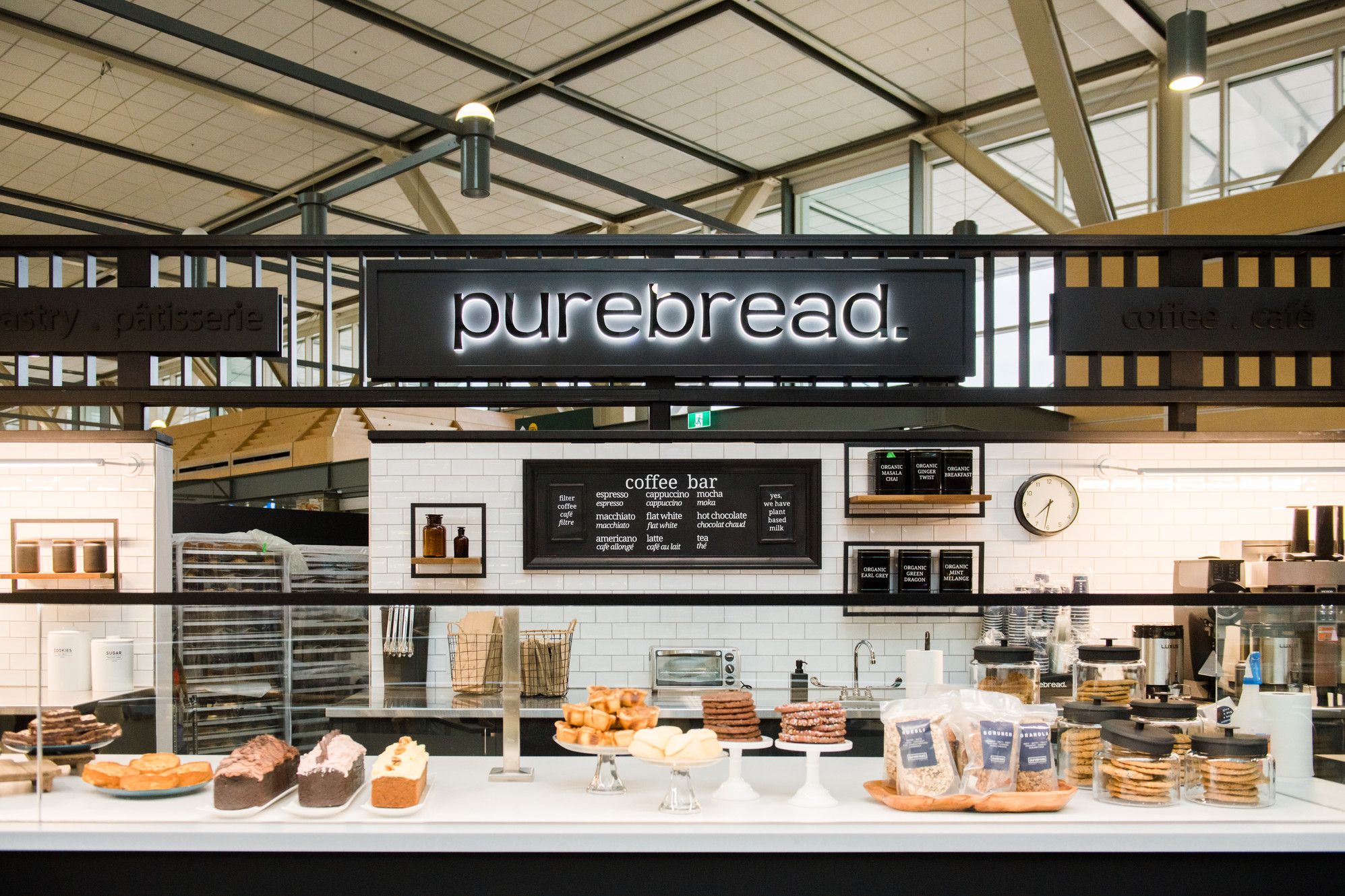 Purebread bakery Vancouver interior showing bustling market-style display of rustic pastries and breads