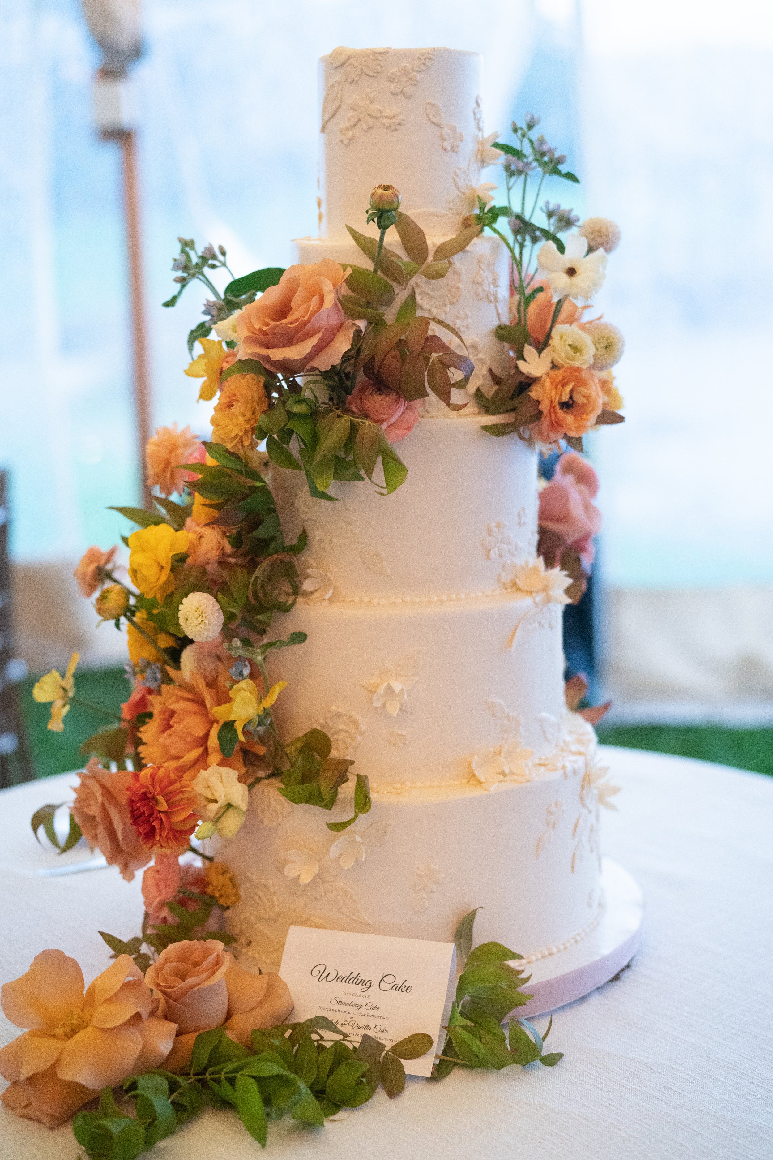 Artisan bakehouse tiered wedding cake with custom floral design and handmade sugar work
