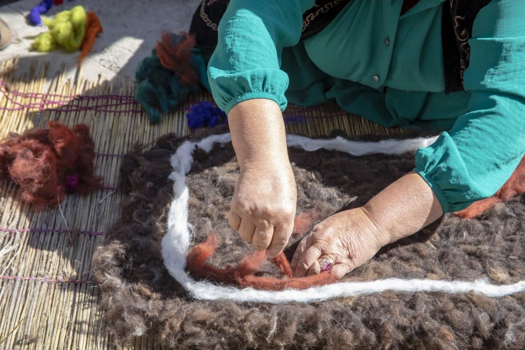 Nepali artisan hands crafting handmade wool felt product traditional technique