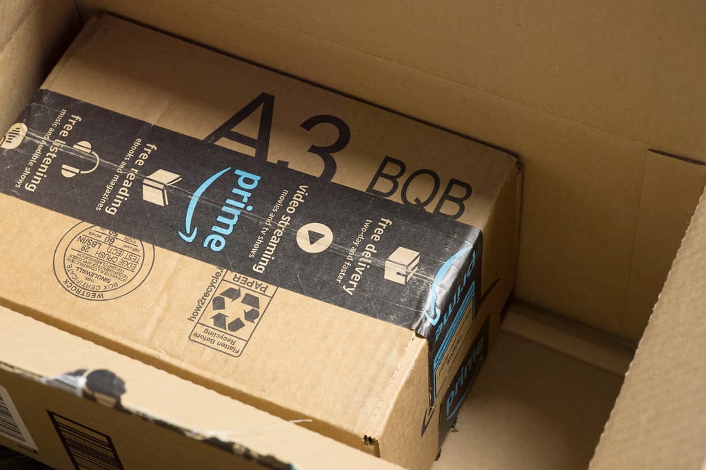 Amazon shipping boxes stacked on wooden pallet illustrating UK ecommerce delivery packaging concerns