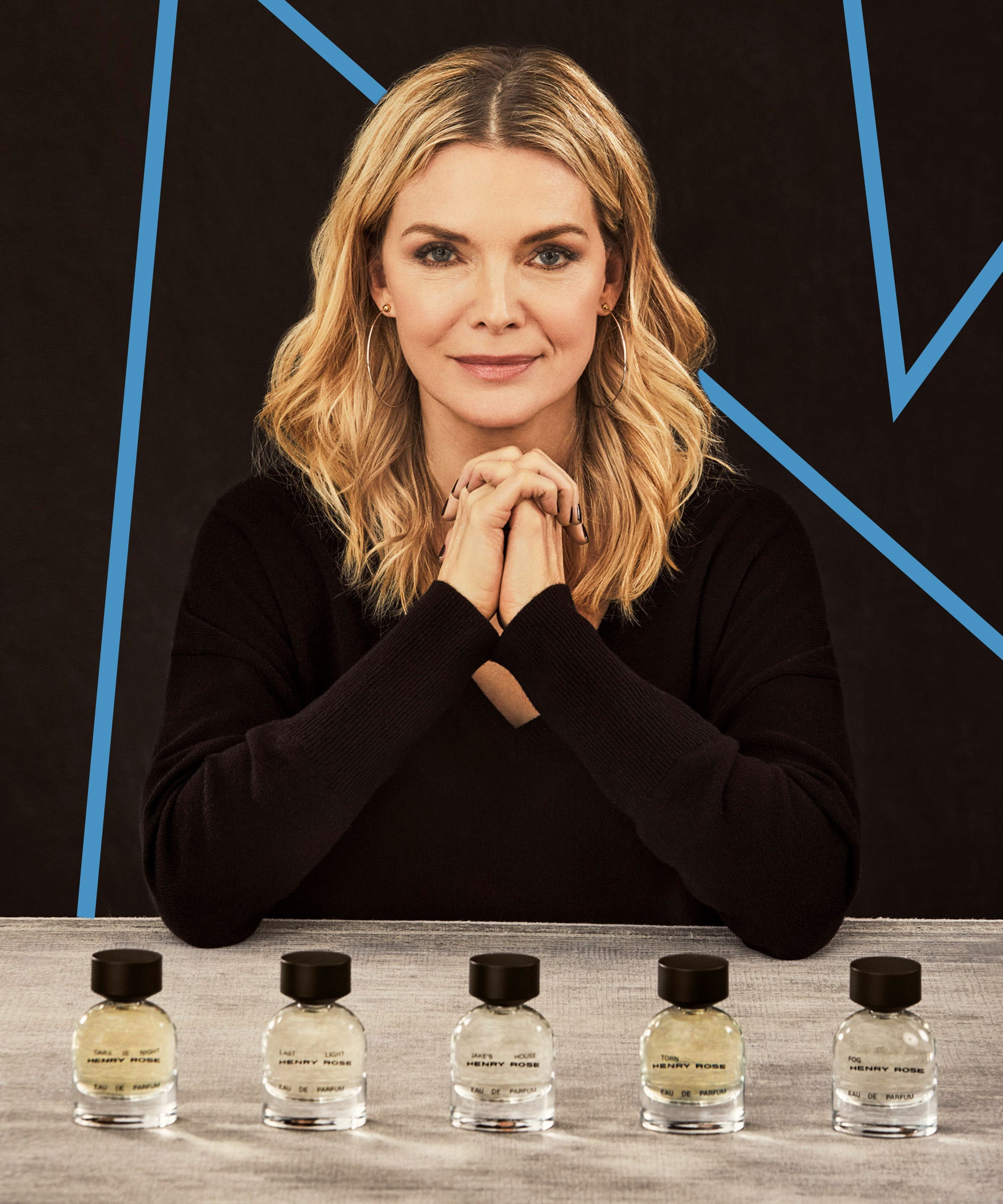 Michelle Pfeiffer Henry Rose clean fragrance brand founder holding perfume bottle in interview