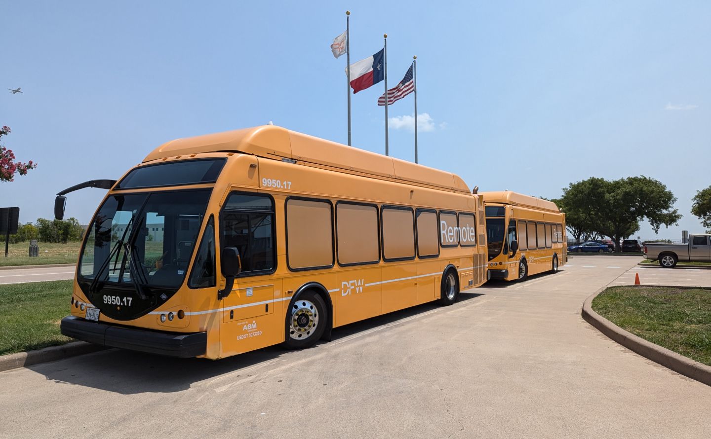 Airport remote parking shuttle bus at terminal drop-off zone illustrating a Park and Ride transfer service