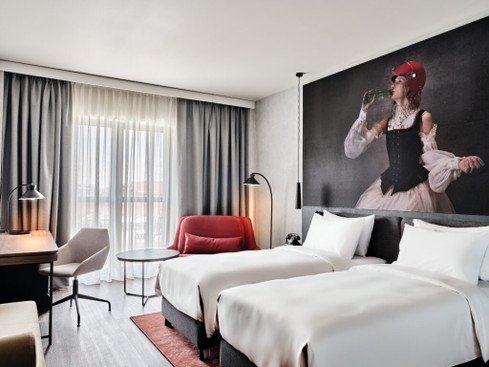 Radisson RED Krakow lifestyle hotel modern lobby with bold design and social lounge area for young travelers