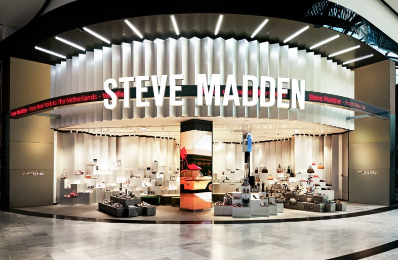 Steve Madden flagship brand store interior showcasing trendy fashion footwear collection displays