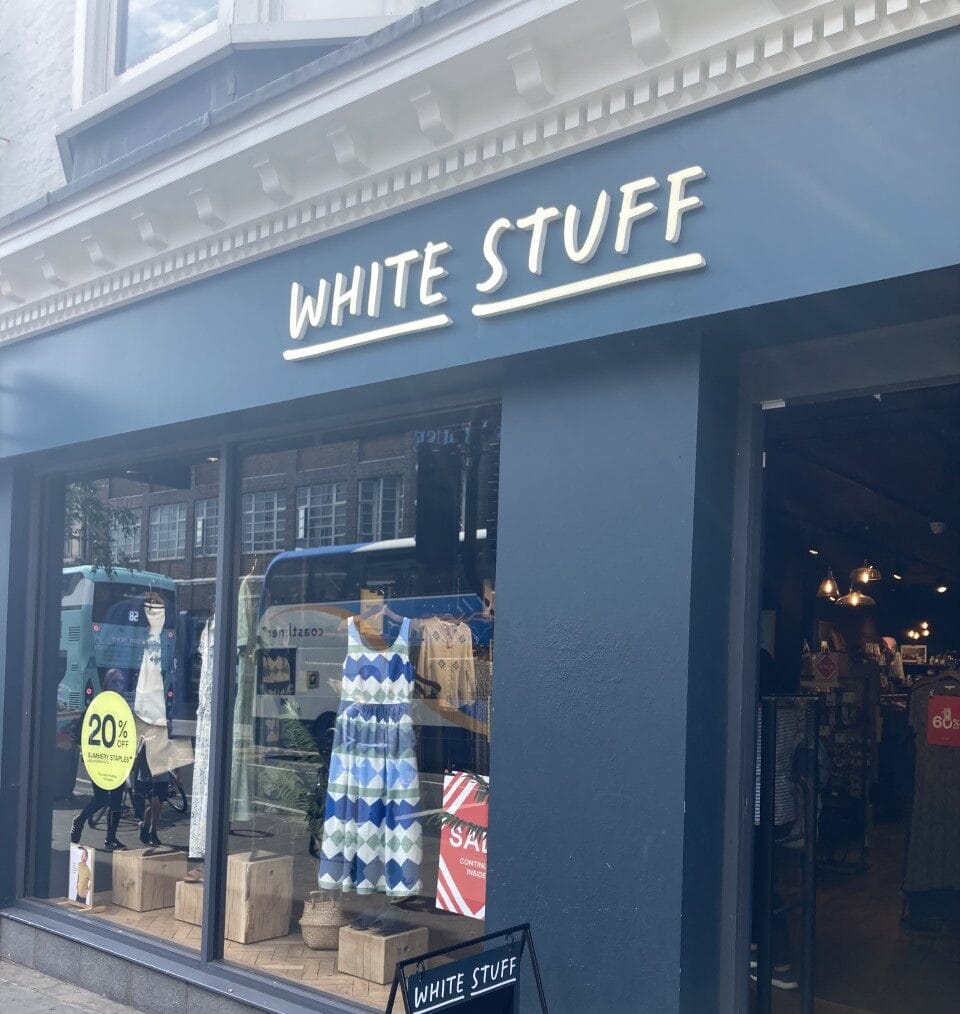 White Stuff British fashion brand storefront showcasing signature quirky window display