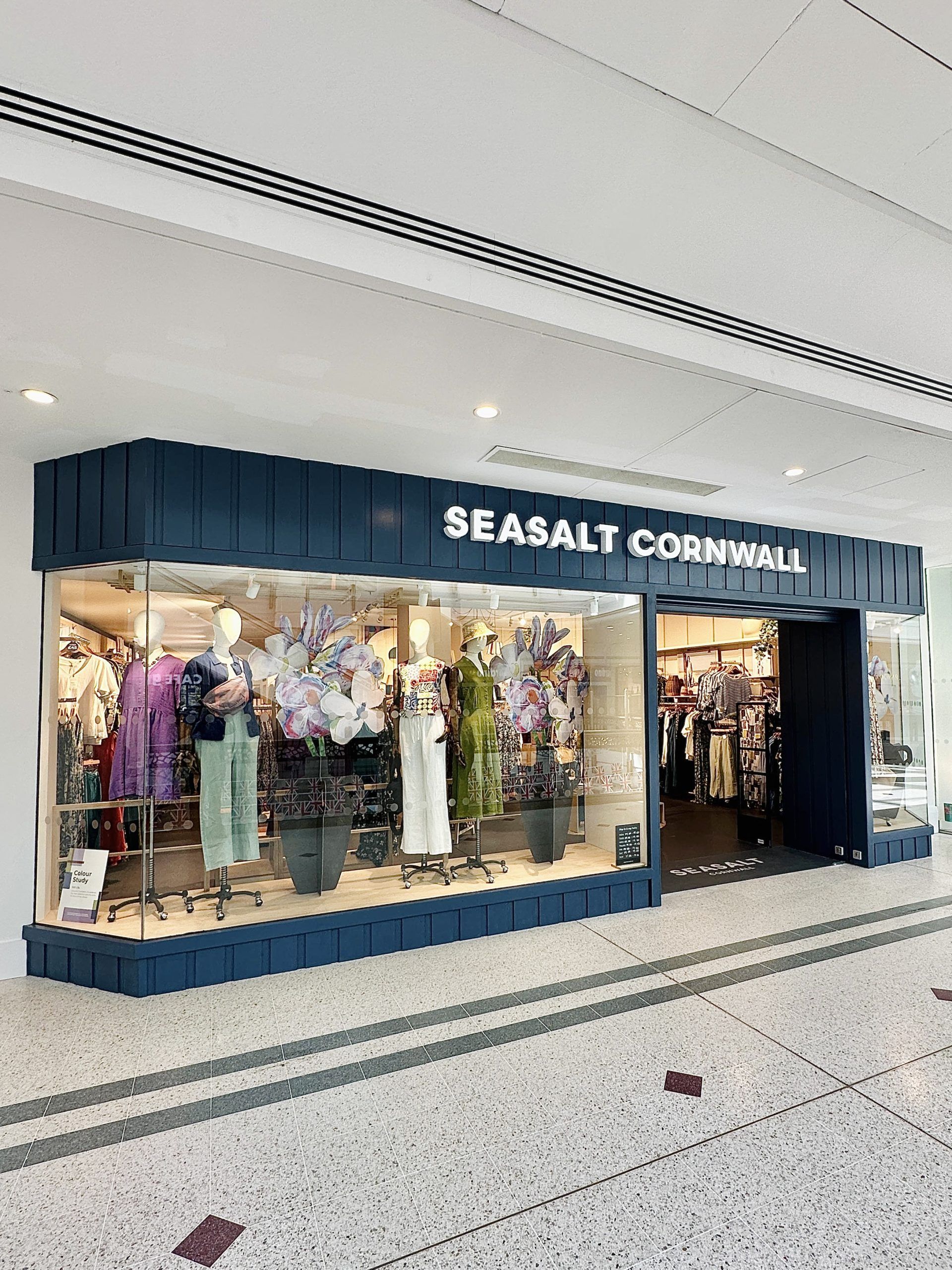 Seasalt Cornwall retail store interior showcasing artistic maritime-inspired clothing collection and organic cotton pieces